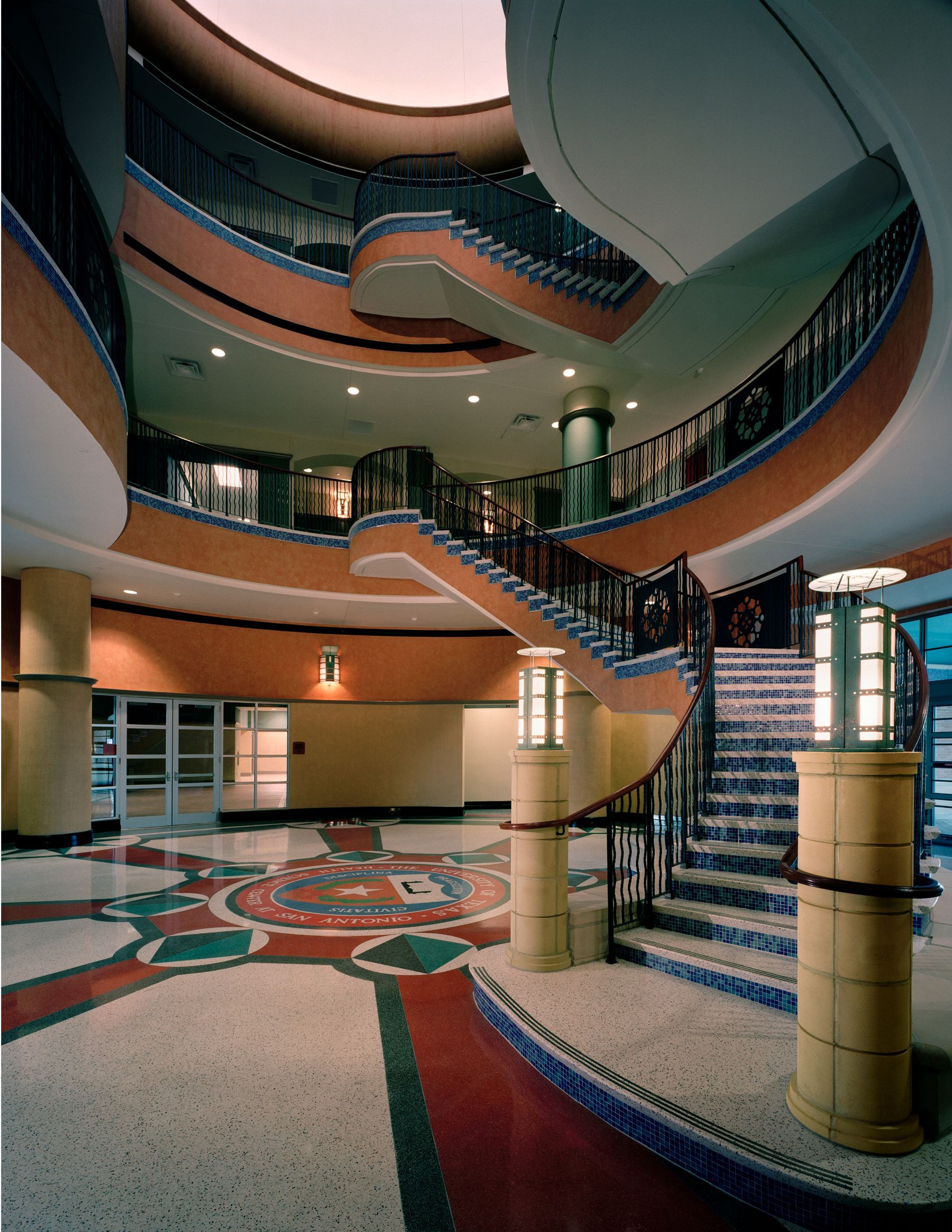 The inside of a building with stairs and columns