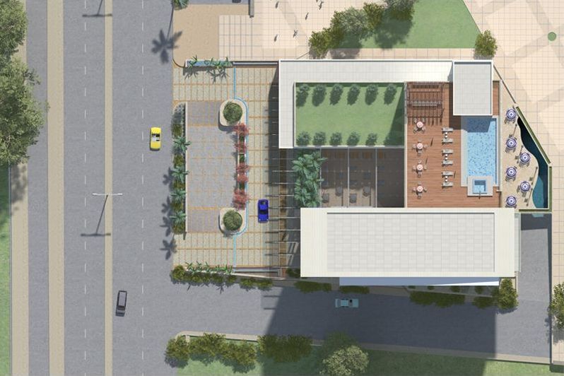 An aerial view of a building with a pool on the roof