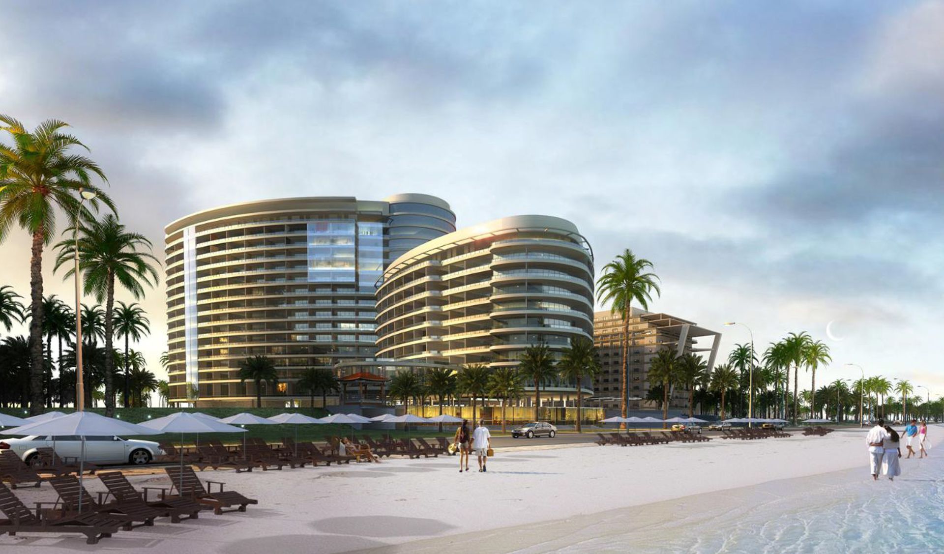 A group of people are walking on a beach next to a large building.