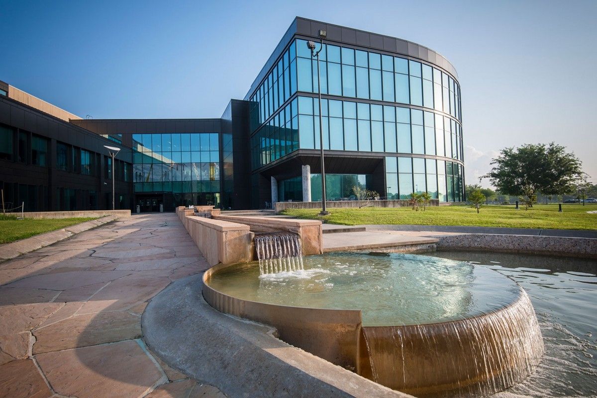 A large building with a fountain in front of it