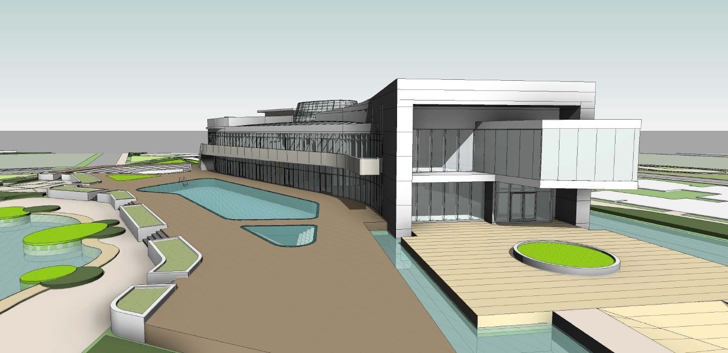 An aerial view of a large building with a pool in front of it.