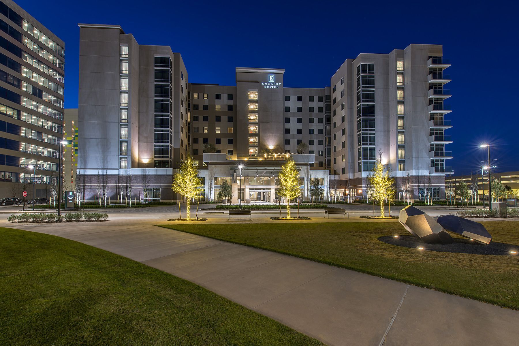 A large building with a lot of windows is lit up at night.