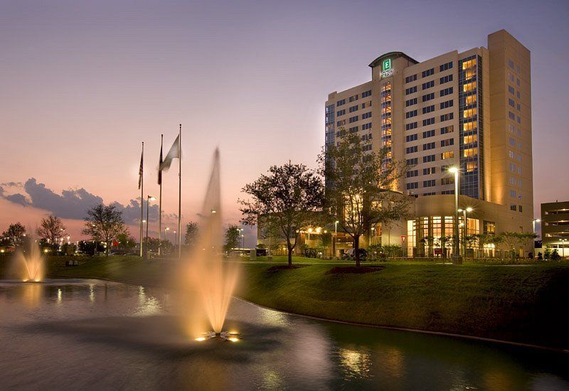A large building with a fountain in front of it