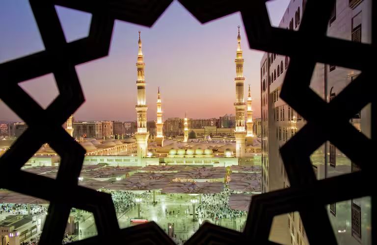 A view of a mosque through a window with a star design