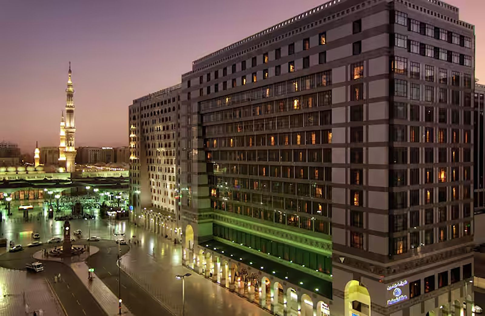 An aerial view of a large building in a city at night.