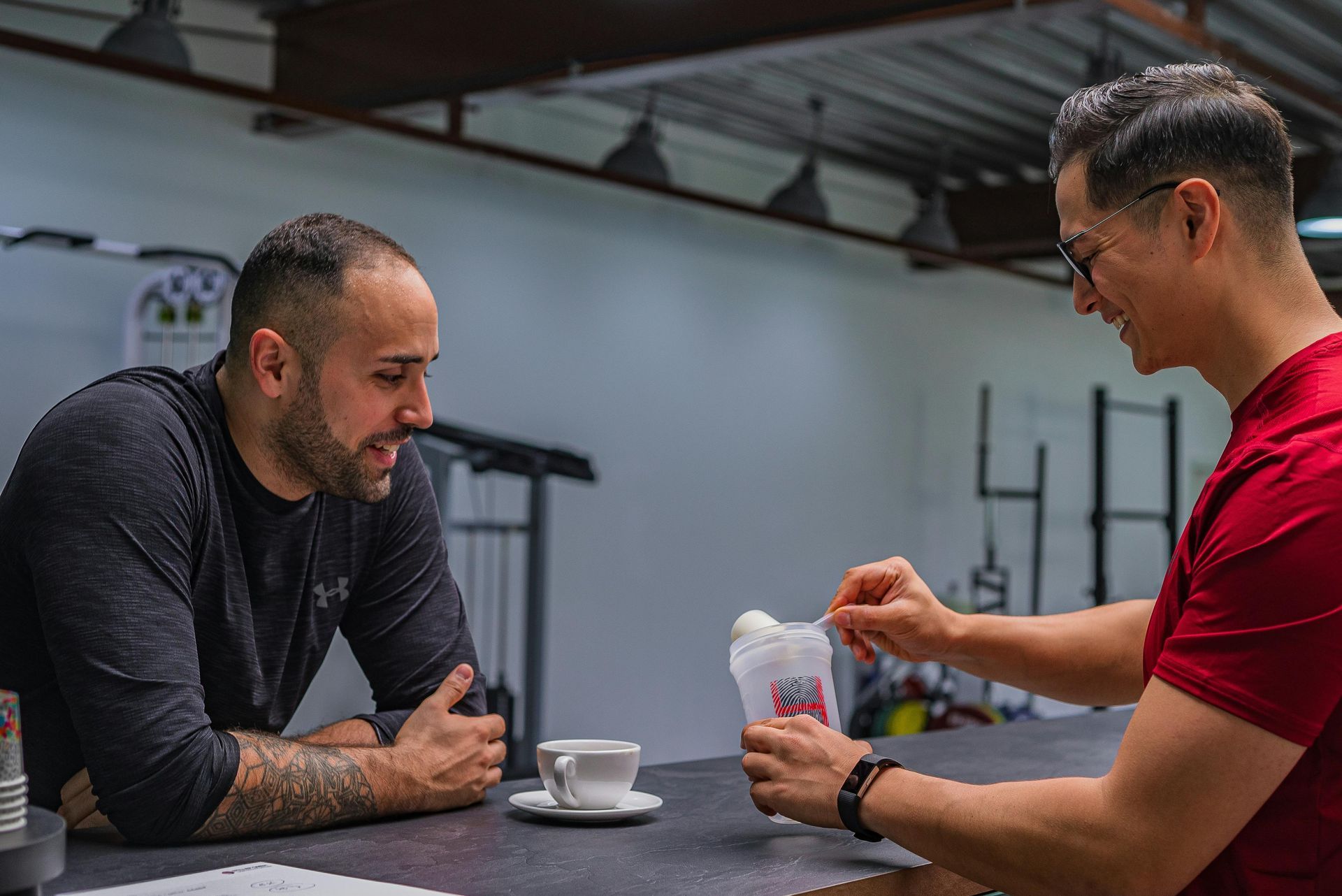 Two men at a table at CrossFit Boiler Room gym  in Villa Rica, GA.