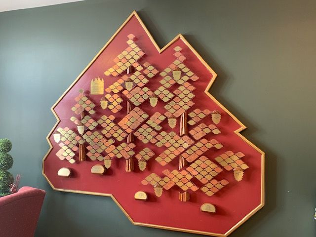 A red and gold map on a grey wall