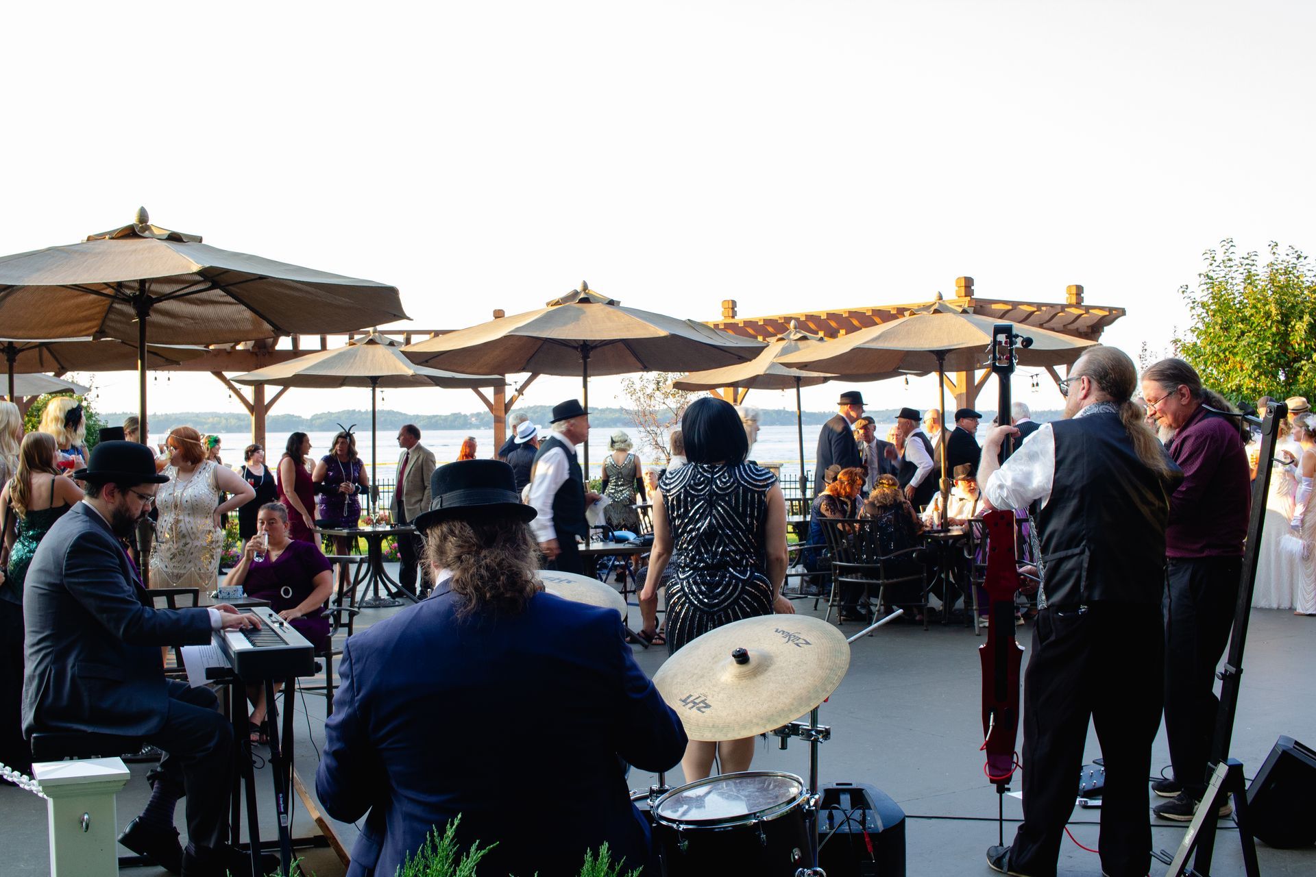 A group of people are dancing and playing instruments at a party.