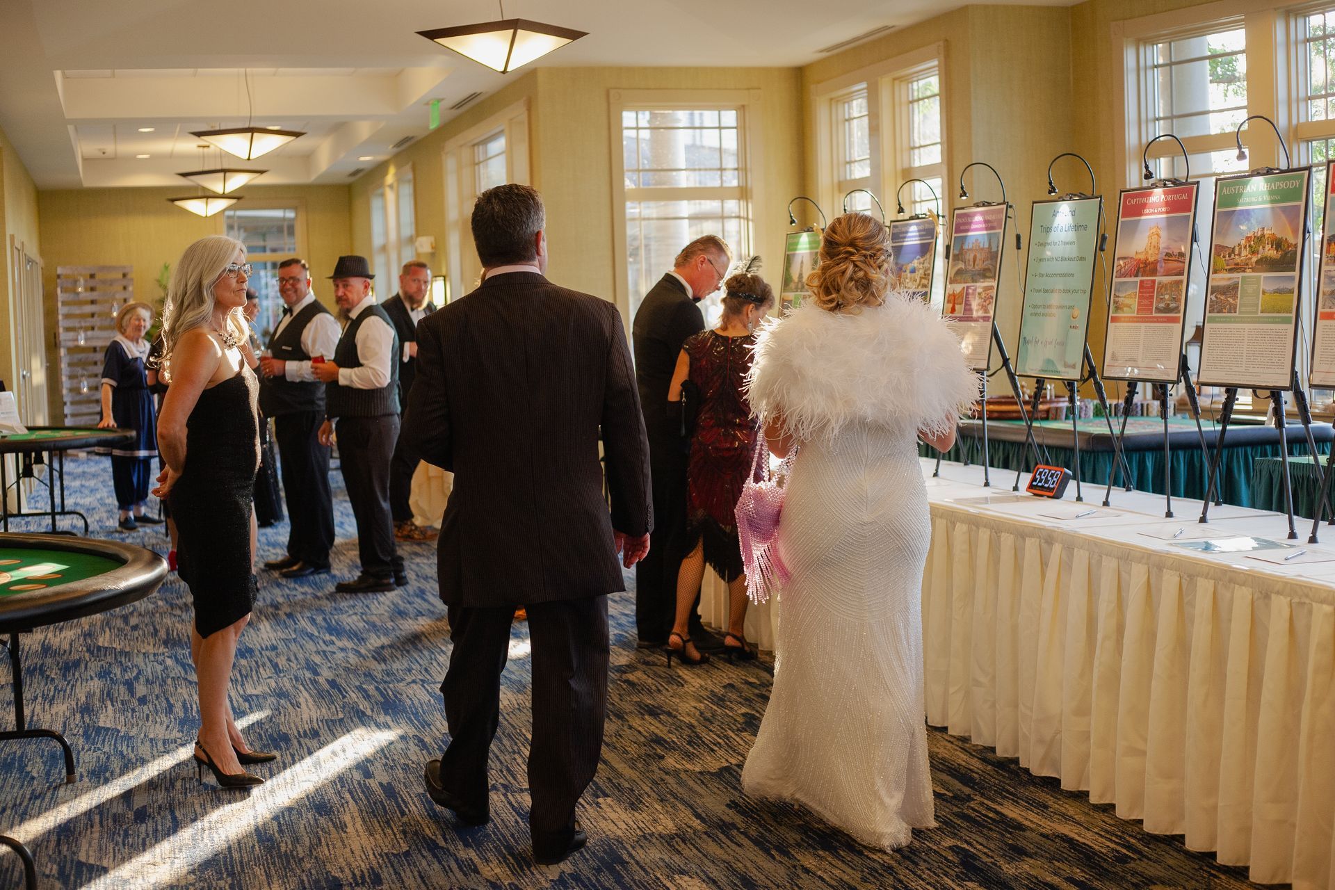 A group of people are standing around a table in a room.