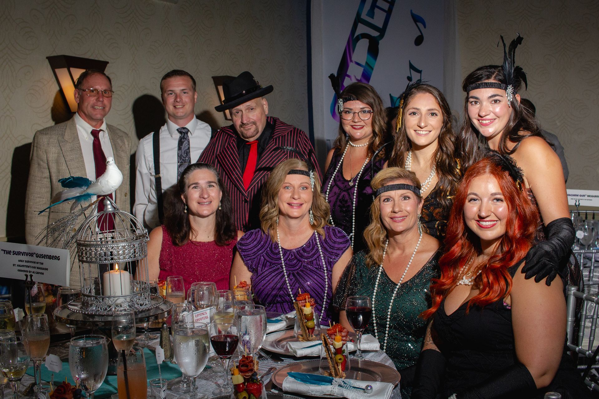 A group of people are posing for a picture at a table.