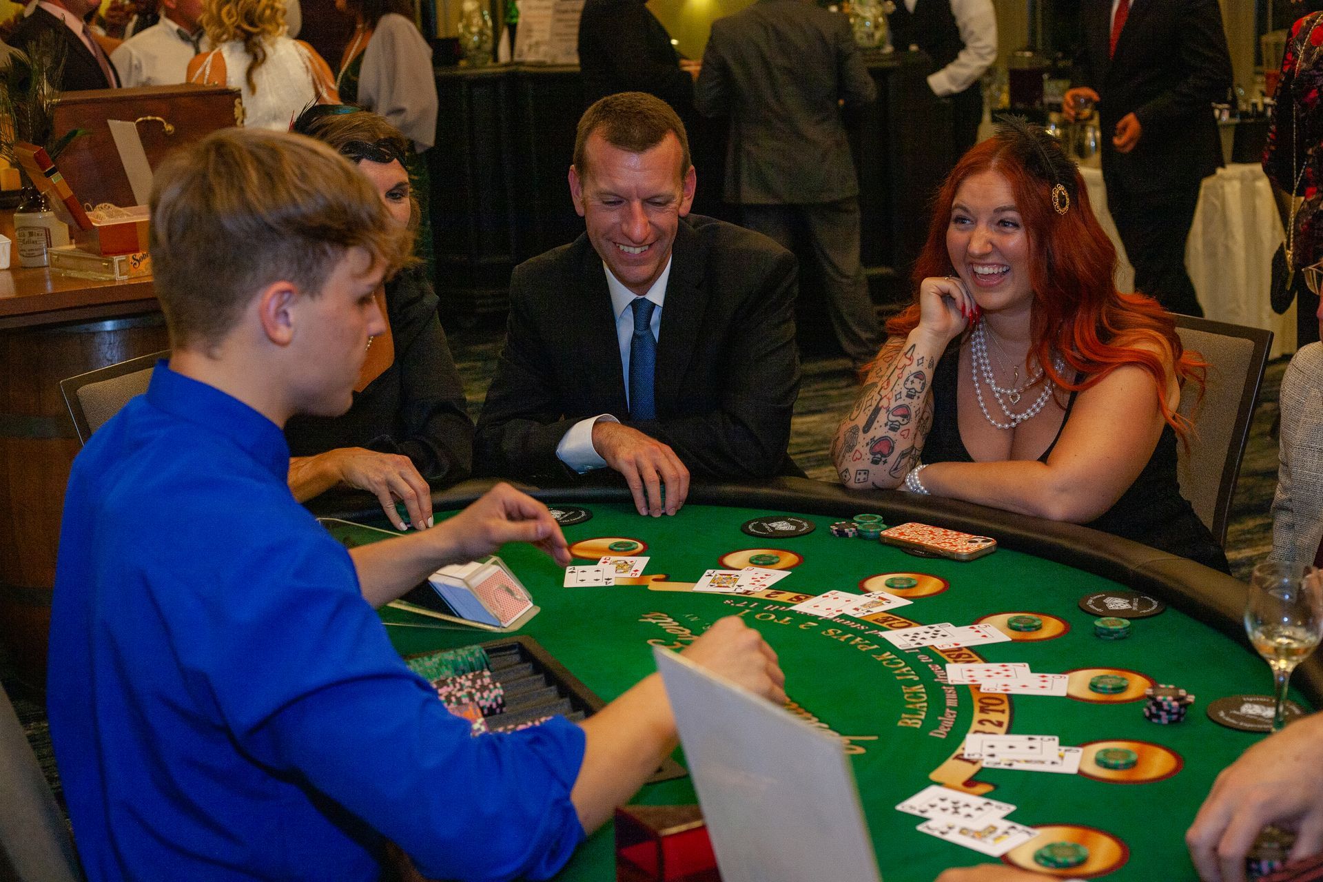 A group of people are playing a game of blackjack at a table.