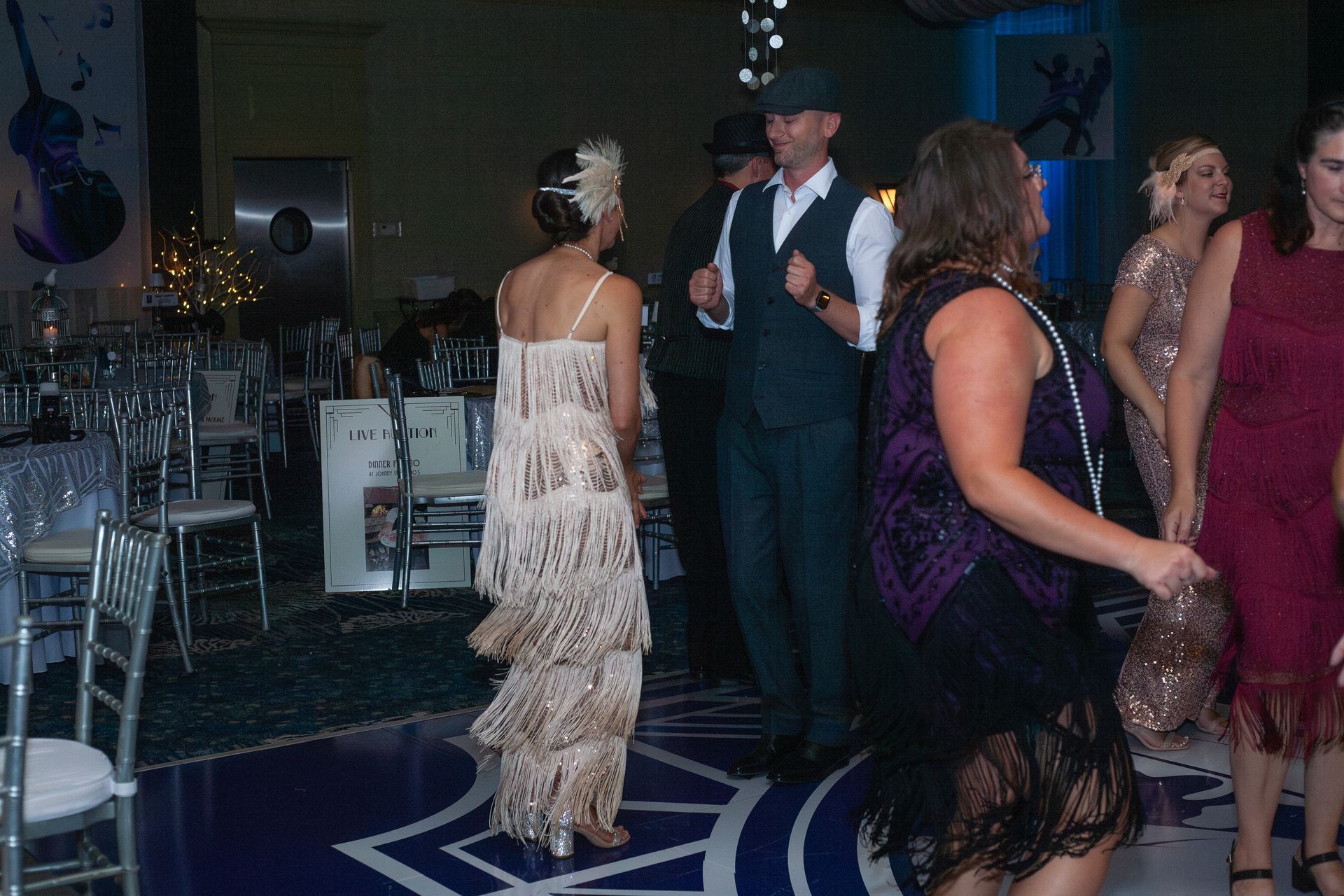 A group of people are dancing on a dance floor