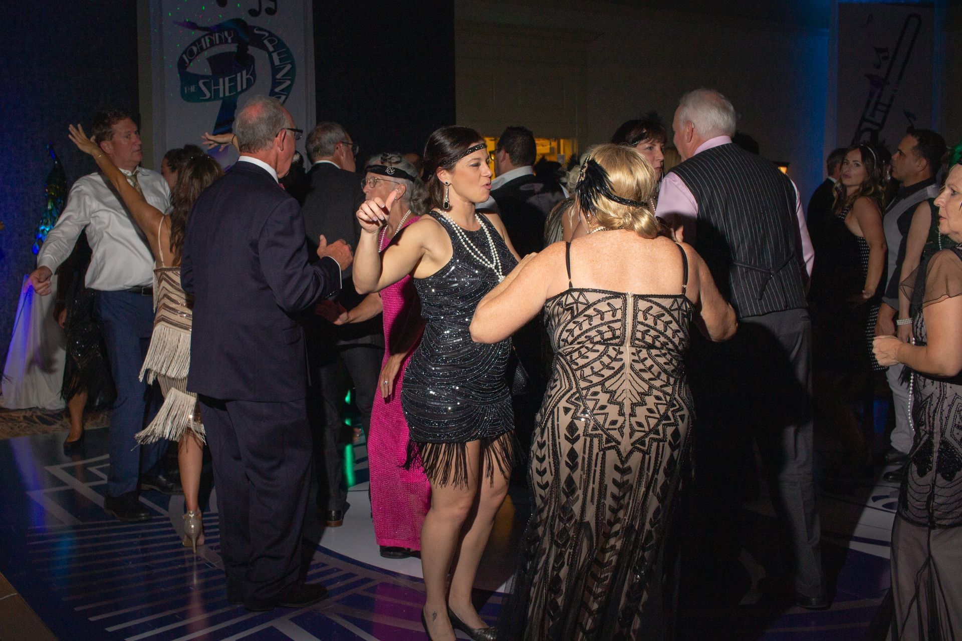 A group of people are dancing on a dance floor