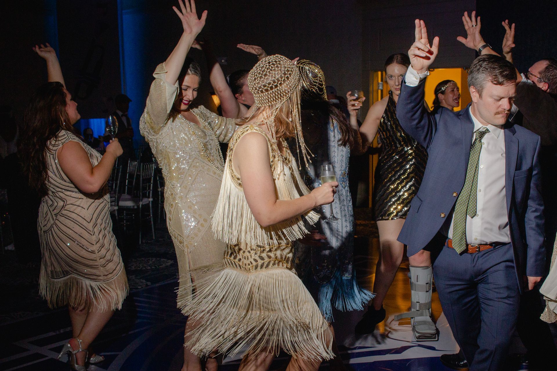 A group of people are dancing on a dance floor at a party.