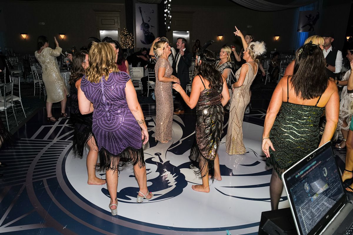 A group of women are dancing on a dance floor at a party.