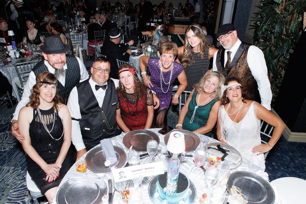 A group of people are posing for a picture at a table.