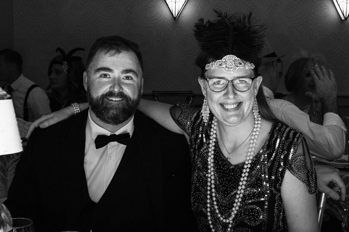 A man and a woman are posing for a picture in a black and white photo.