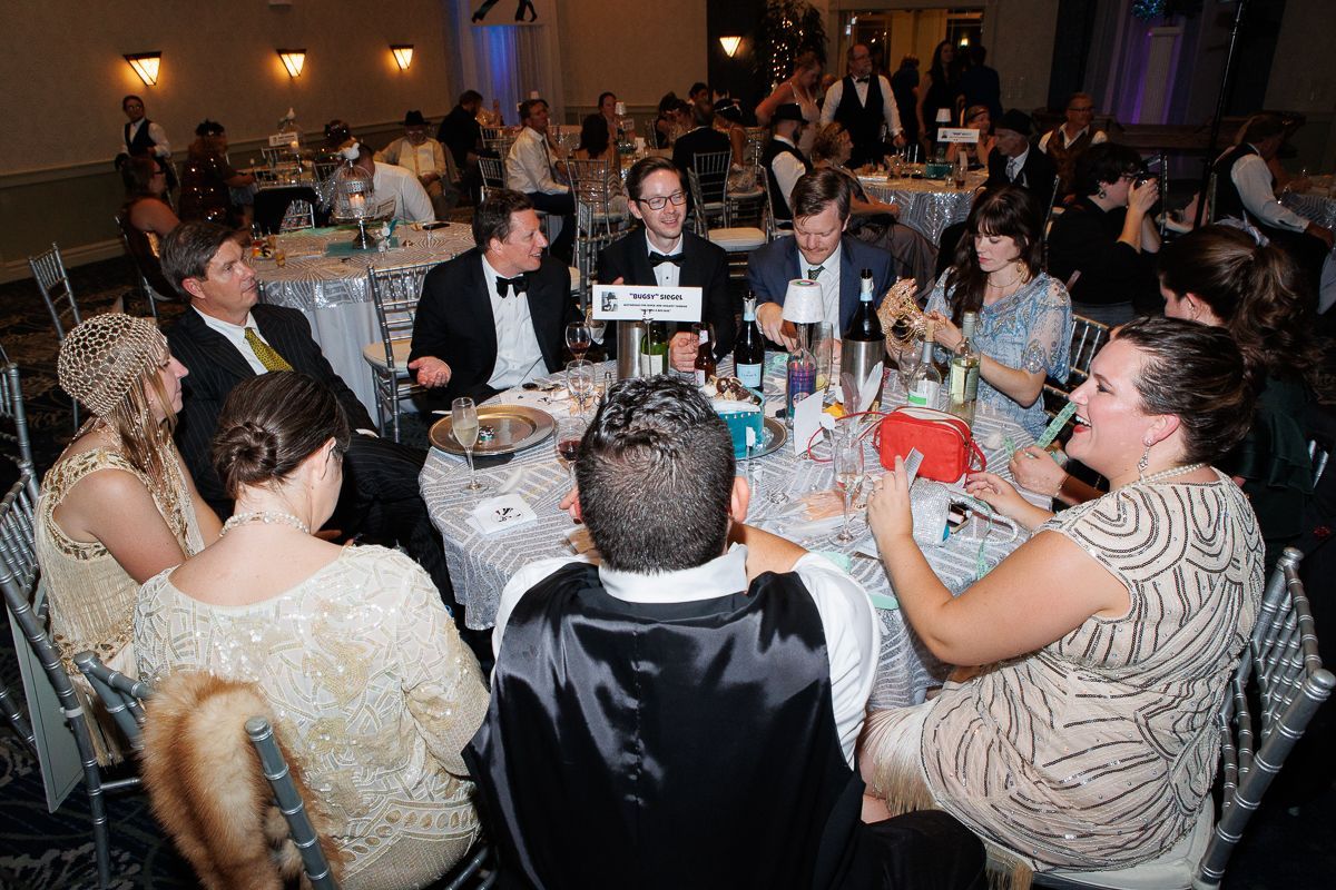 A group of people are sitting around a table at a party.