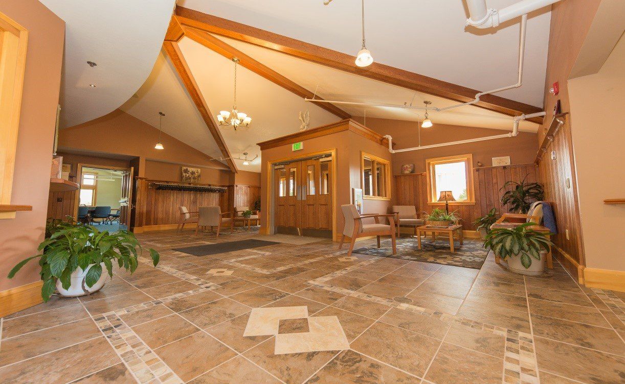 A large room with a tiled floor and a wooden ceiling.
