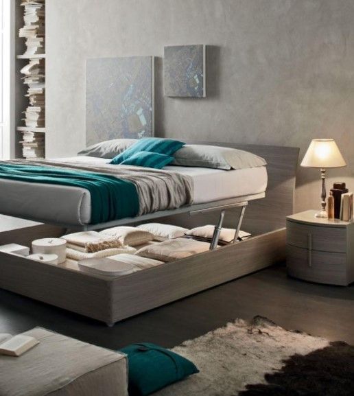 Una camera da letto con un letto che ha un cassetto sotto