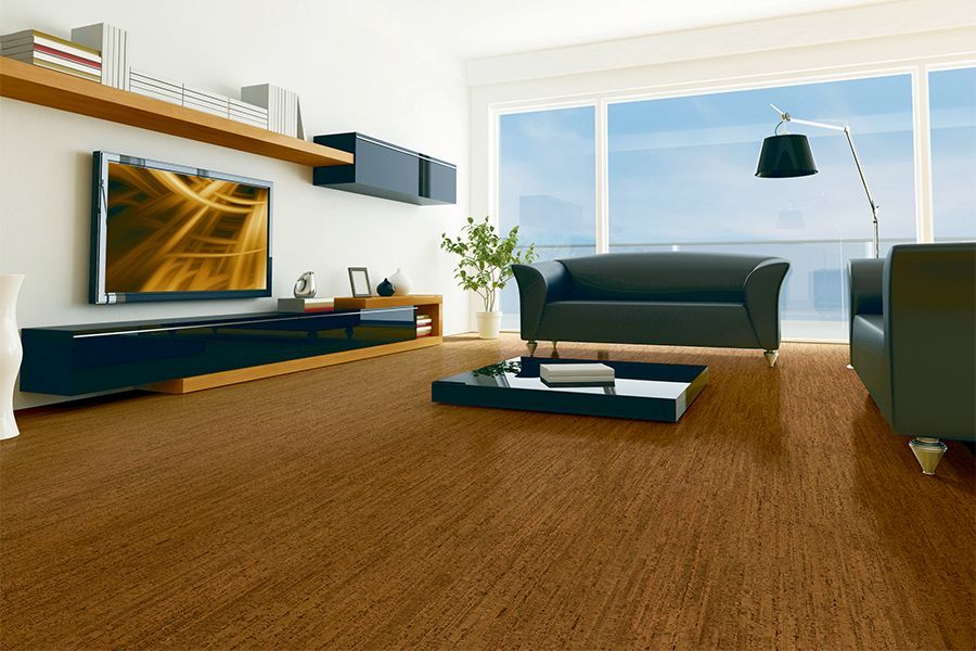 Modern living room with large window, brown carpet, dark sofa, TV, and coffee table
