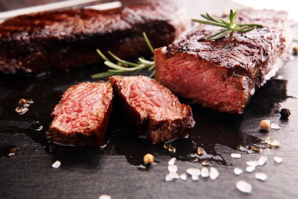 Cooked Steak With Salt in a Cutting Board — Romanas Italian Restaurant in Mermaid Beach, QLD