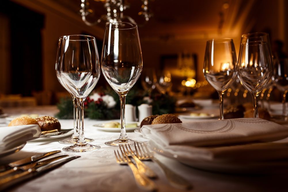 Elegant Candlelit Dinner Table With Wine Glasses — Romanas Italian Restaurant in Mermaid Beach, QLD