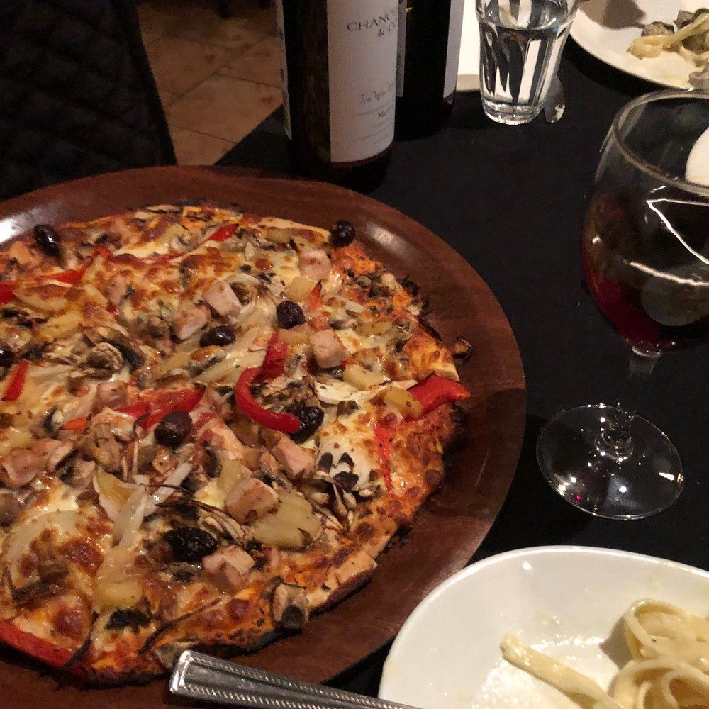 A Restaurant With Tables and Chairs and a Bar — Romanas Italian Restaurant in Mermaid Beach, QLD