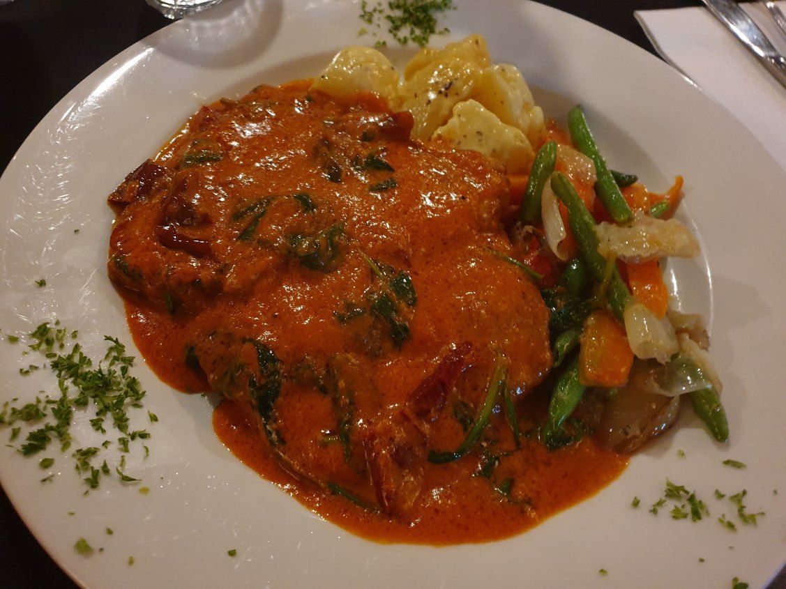 A Plate of Food With Meat and Vegetables on a Table — Romanas Italian Restaurant in Mermaid Beach, QLD