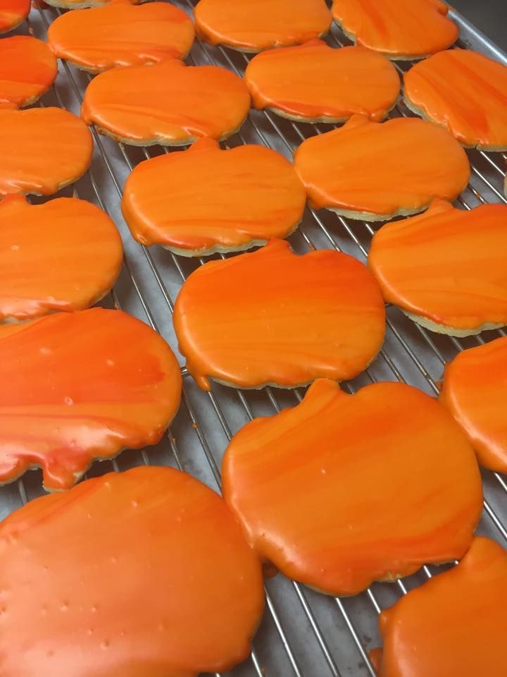 a bunch of orange cookies in the shape of pumpkins