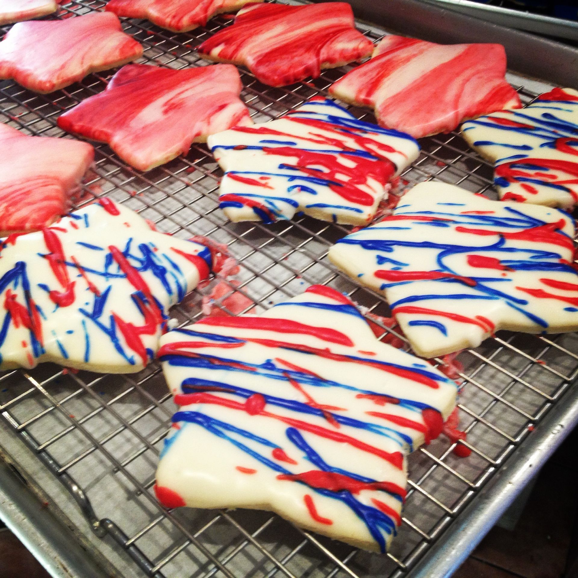 red white and blue star shaped cookies on a cooling rack