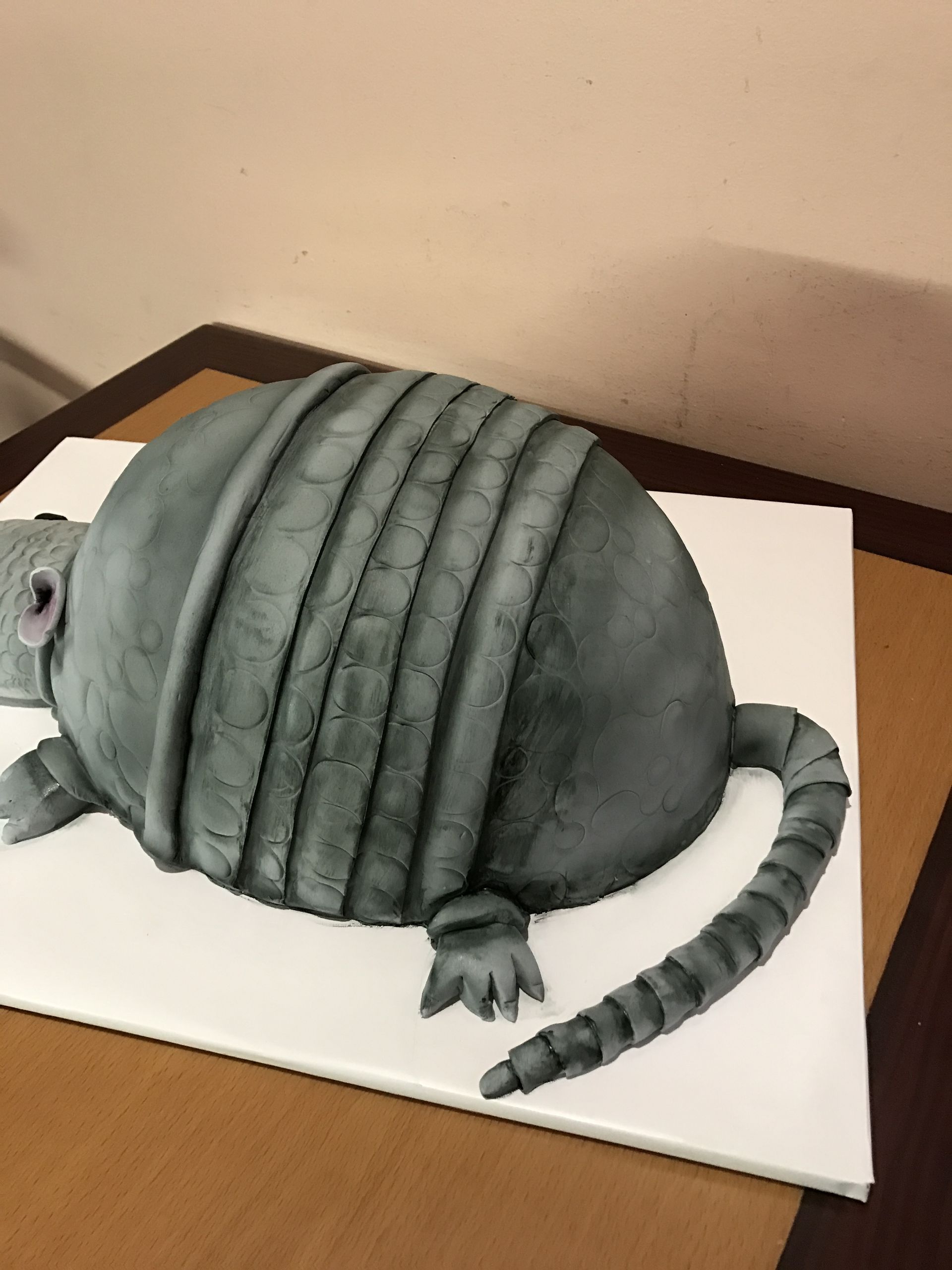 a cake in the shape of an armadillo on a table