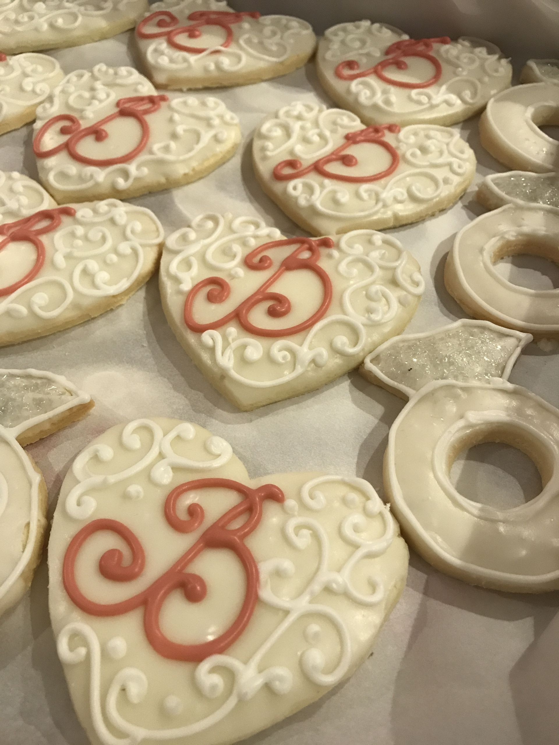 a bunch of heart shaped cookies with the letter b on them