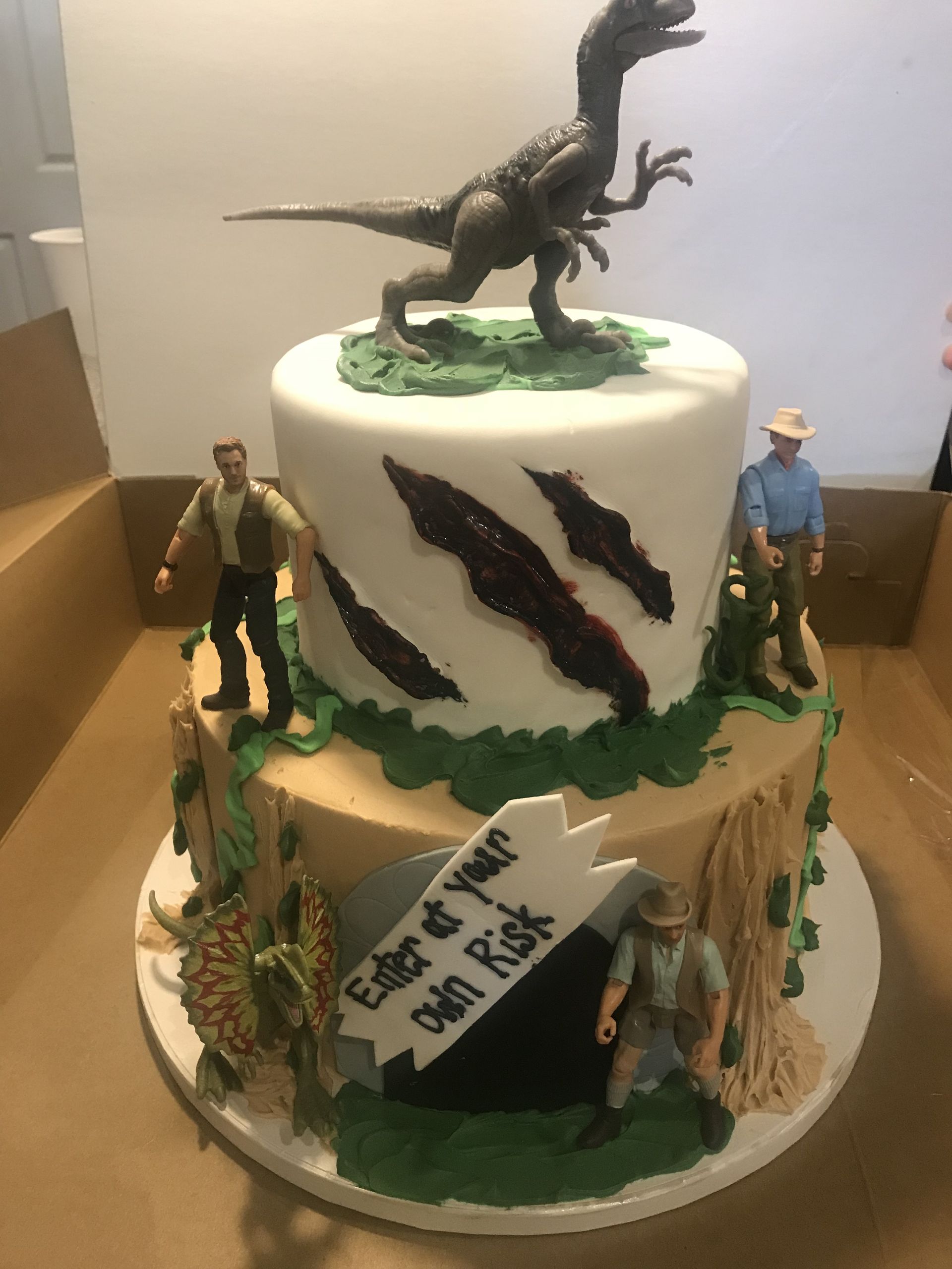a cake with a dinosaur on top of it