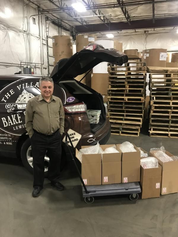 a man is standing in front of a van that says the villa bake