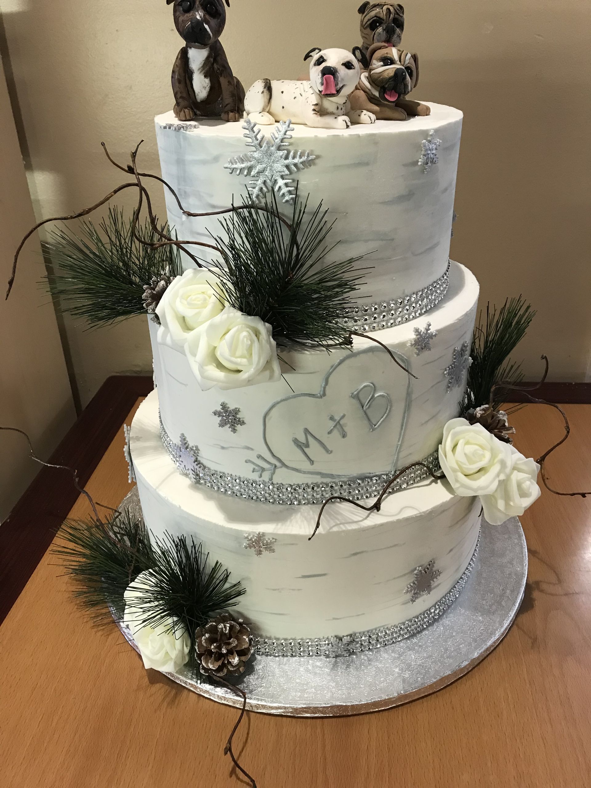 a wedding cake with three dogs on top of it