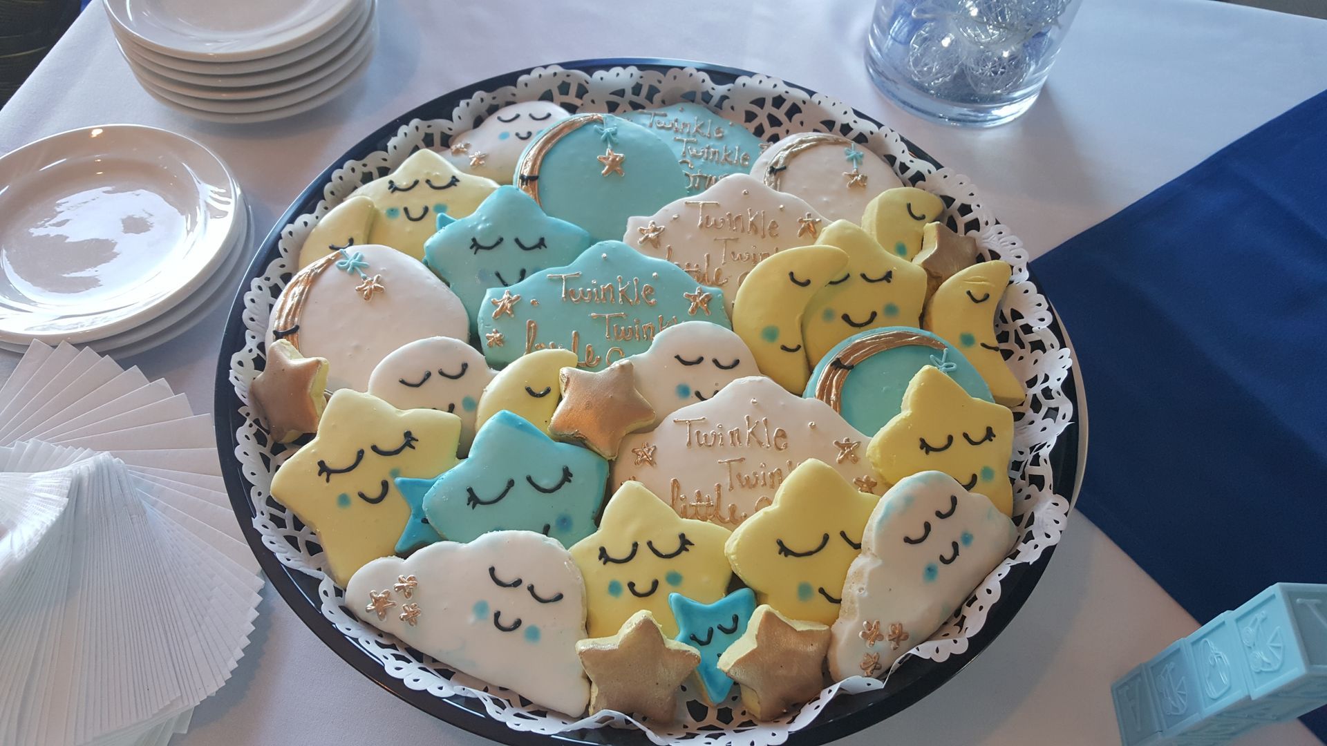 a plate of cookies with clouds and stars on them