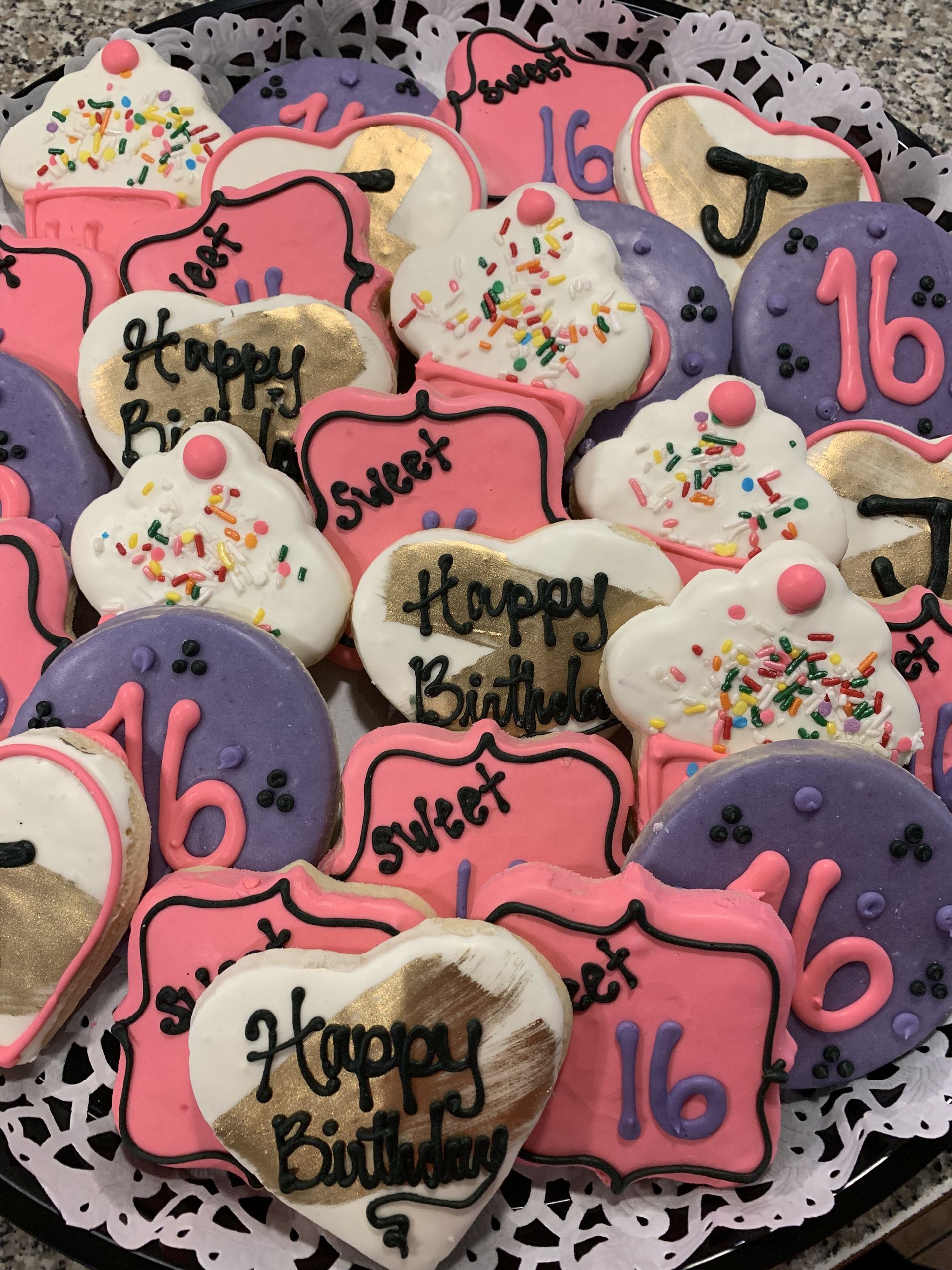 a tray of cookies with one that says happy birthday