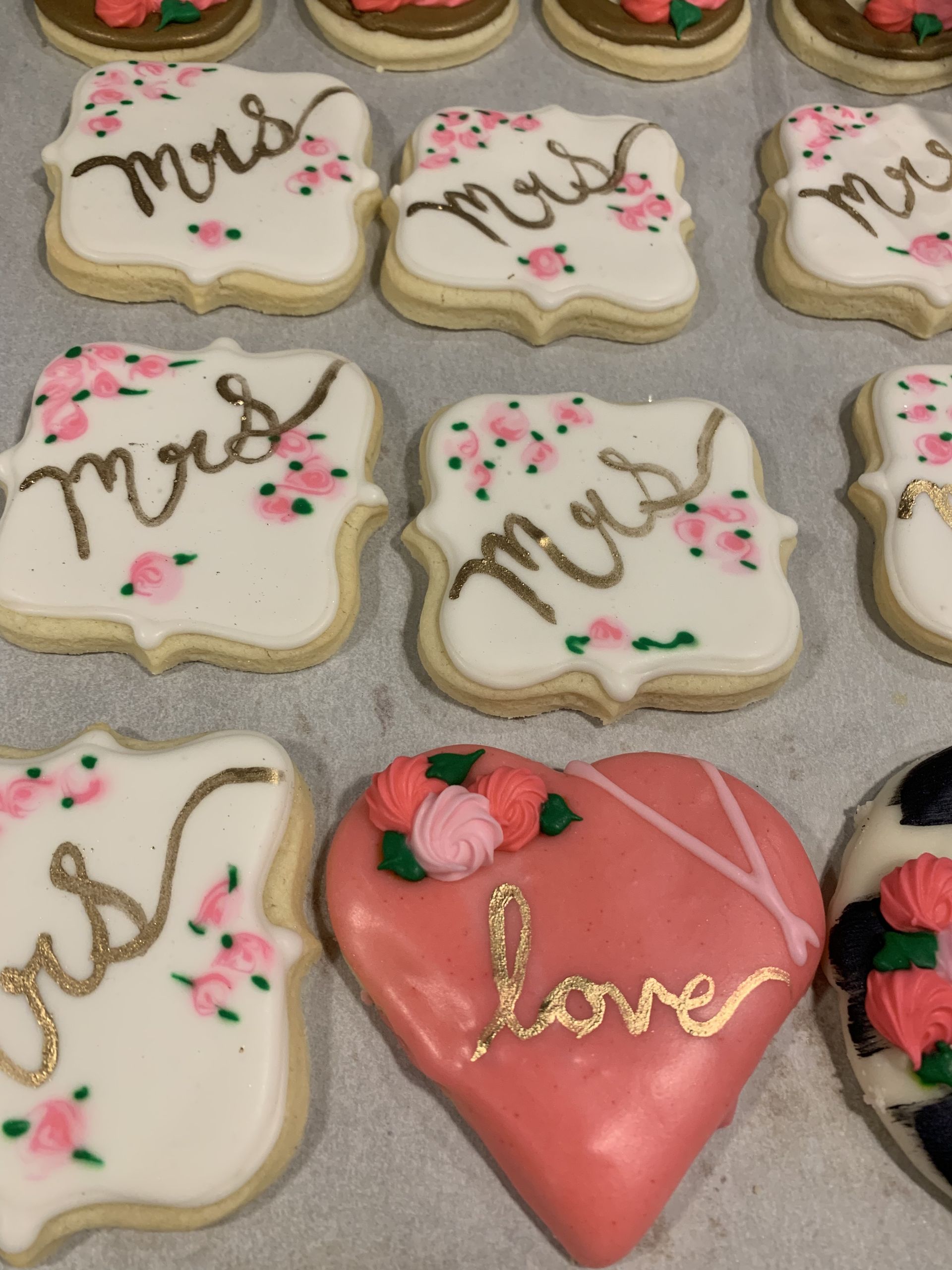 a bunch of mrs. and mr.s. cookies on a table