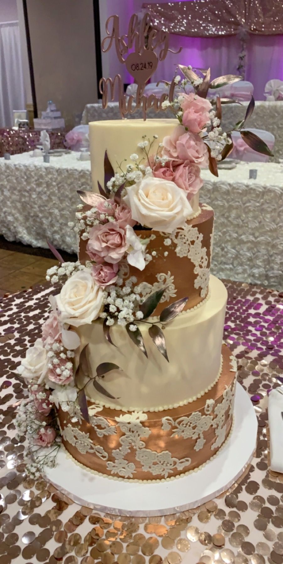 a wedding cake with flowers on it is sitting on a table .