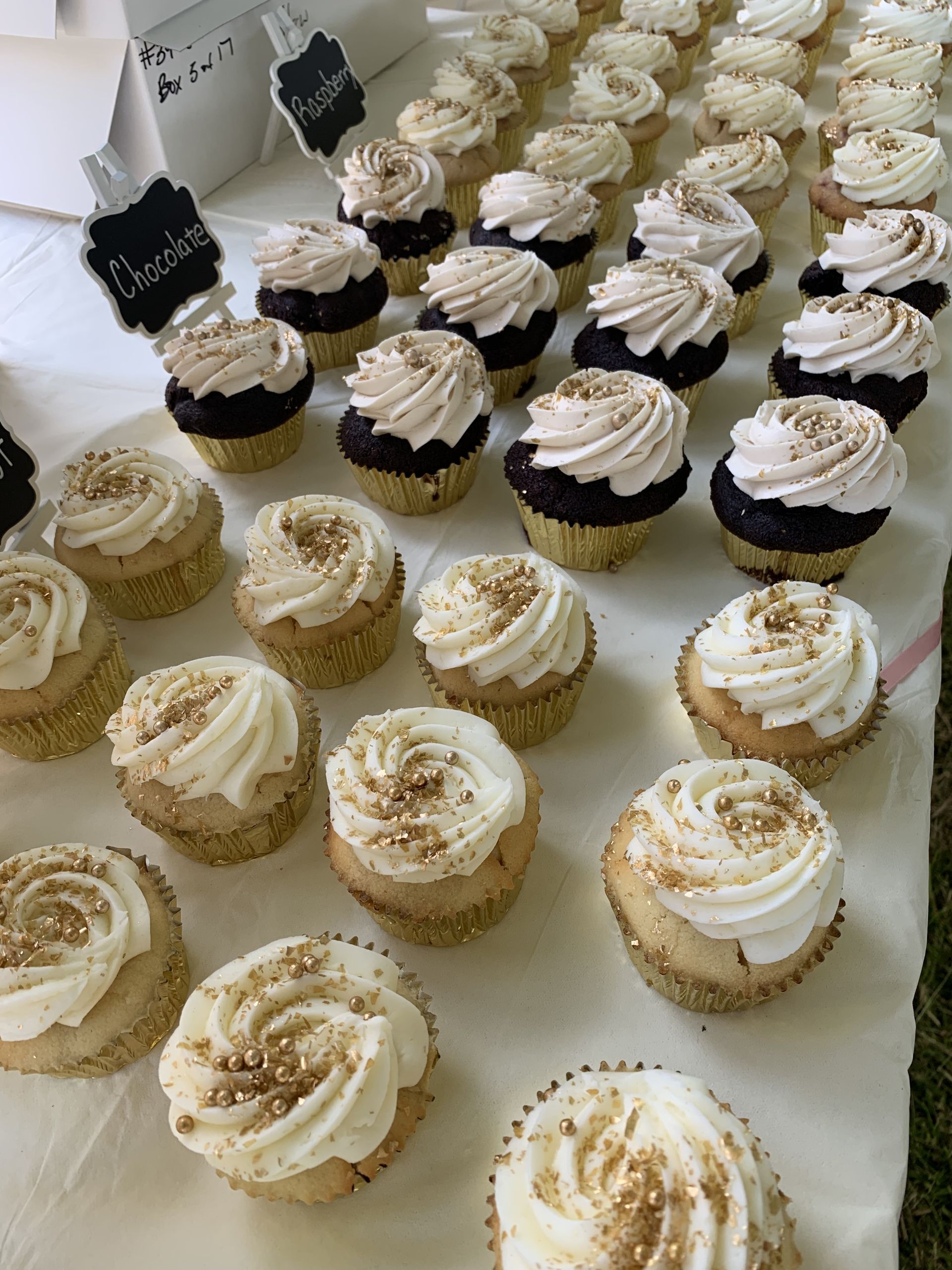 a bunch of cupcakes with frosting on them are sitting on a table .