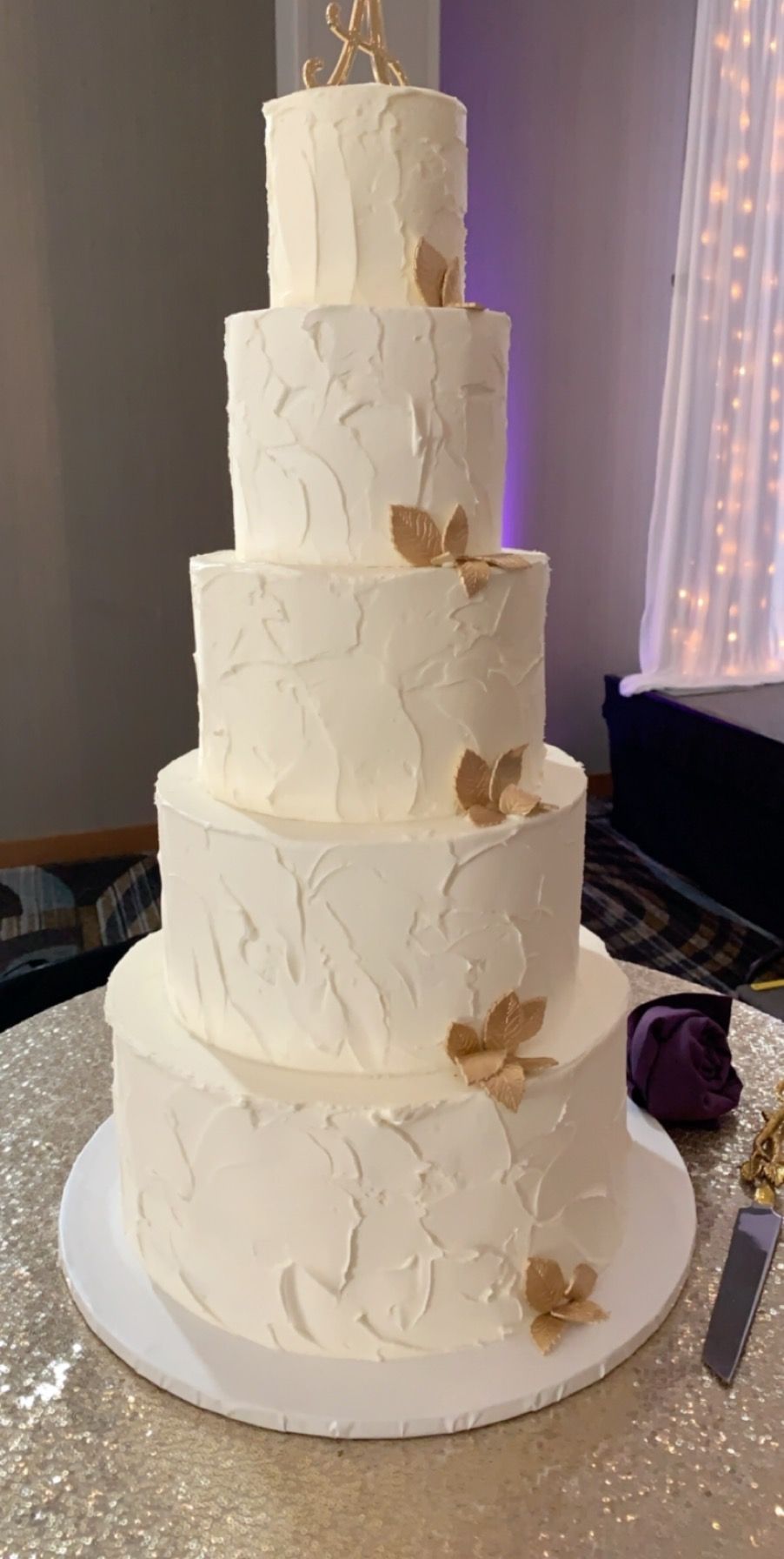 a white wedding cake is sitting on top of a table .