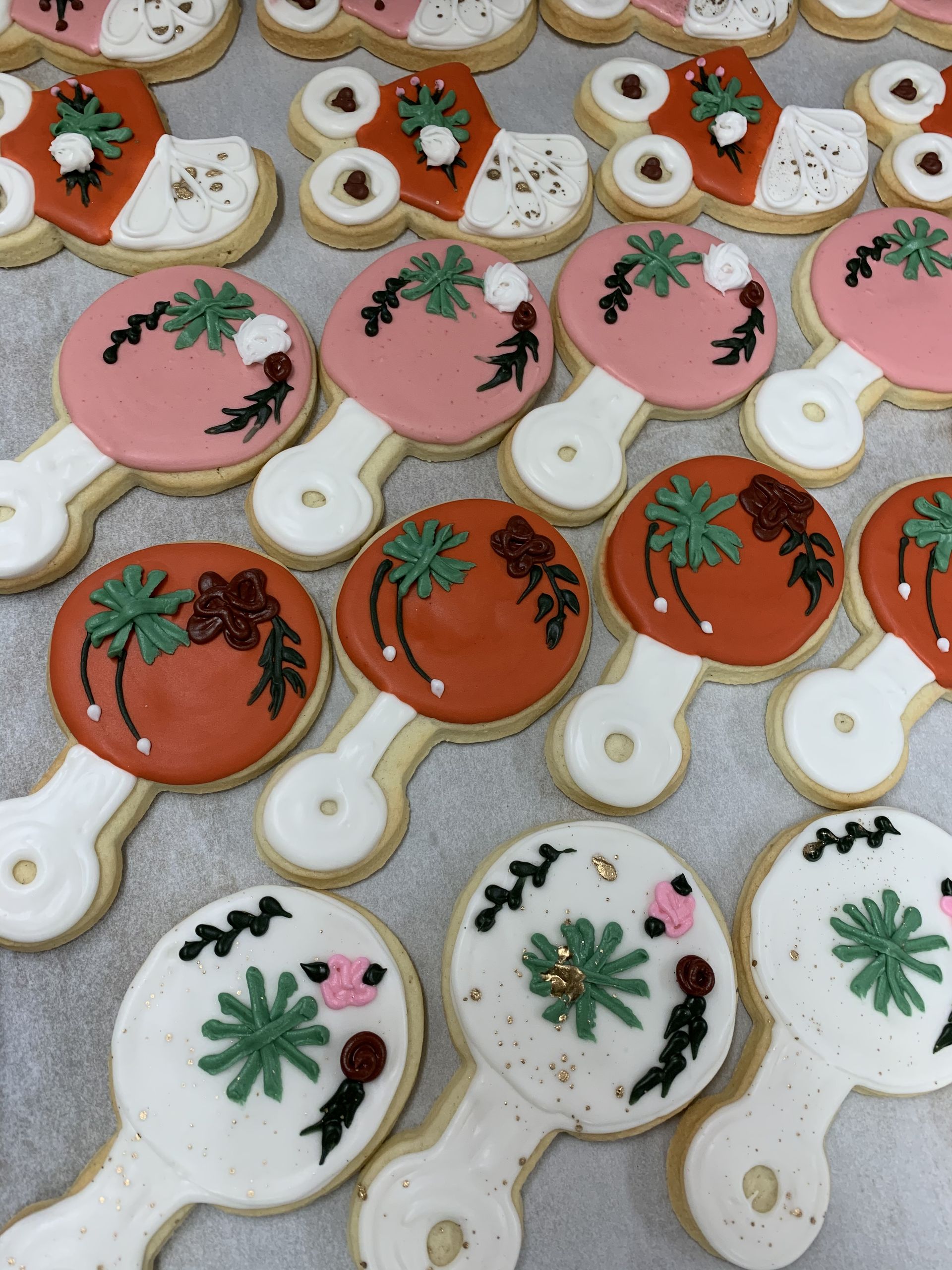 a bunch of cookies with palm trees and flowers on them