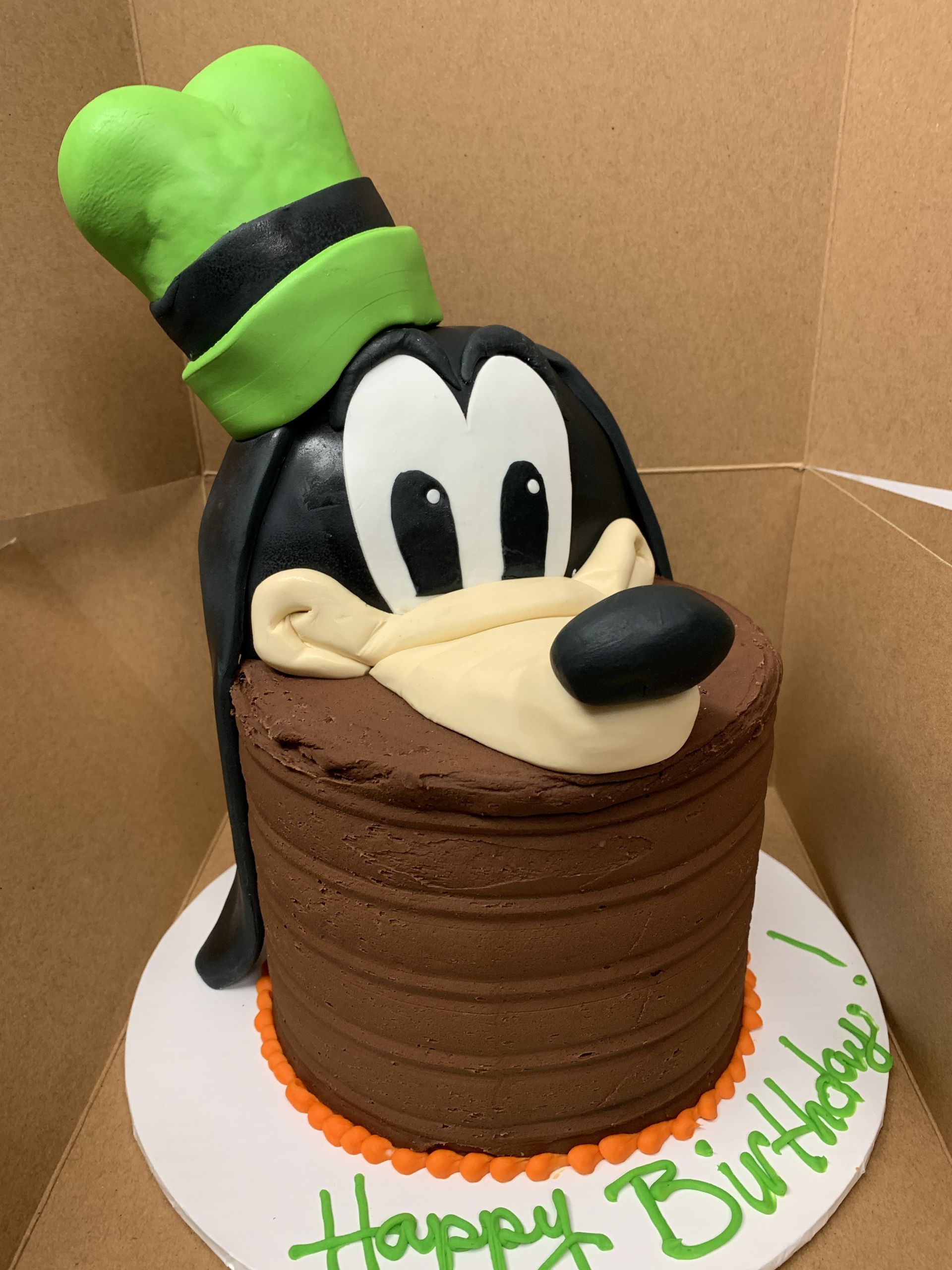 a birthday cake with goofy 's face on it