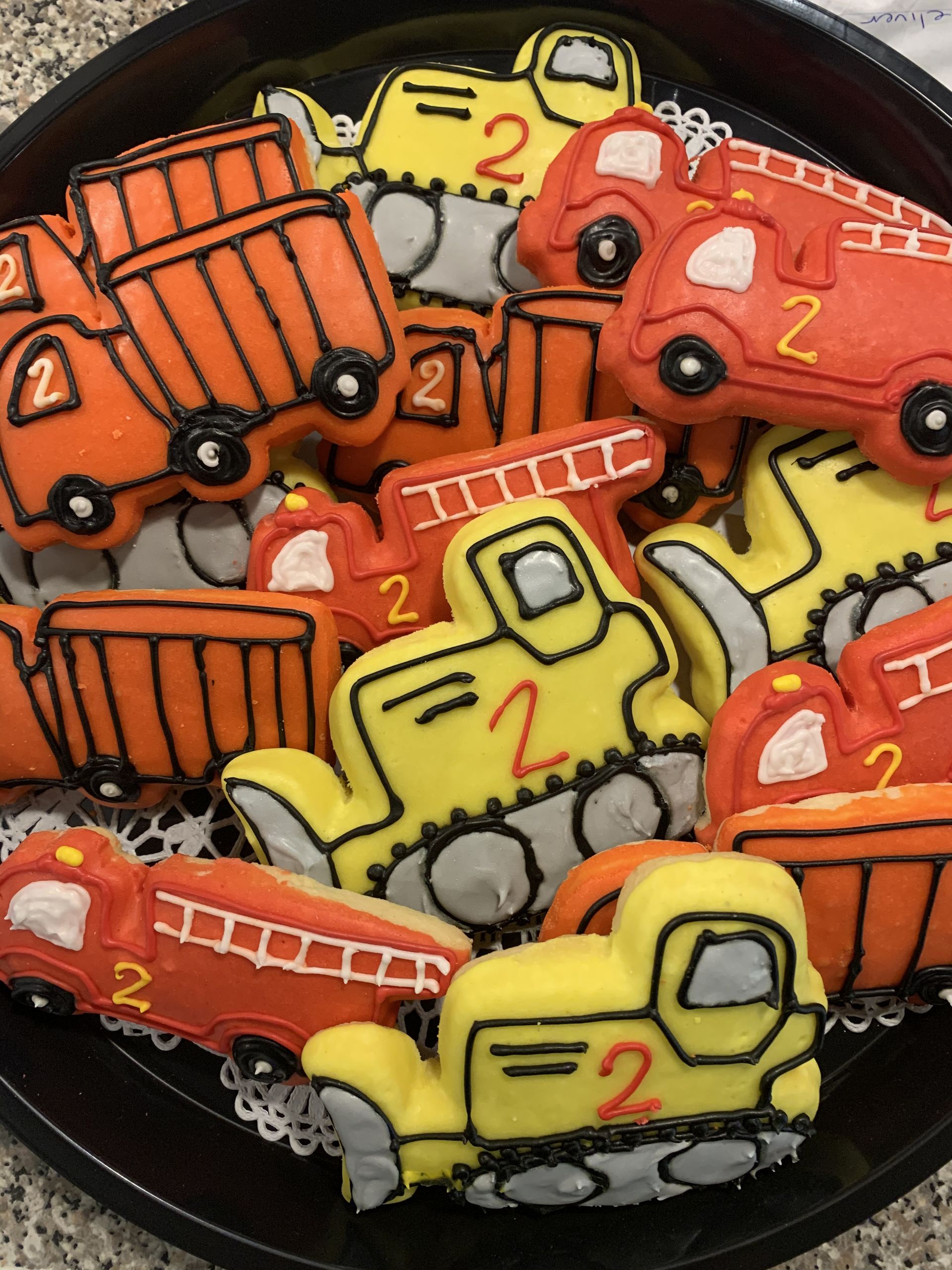a bunch of cookies in the shape of construction vehicles with the number 2 on them
