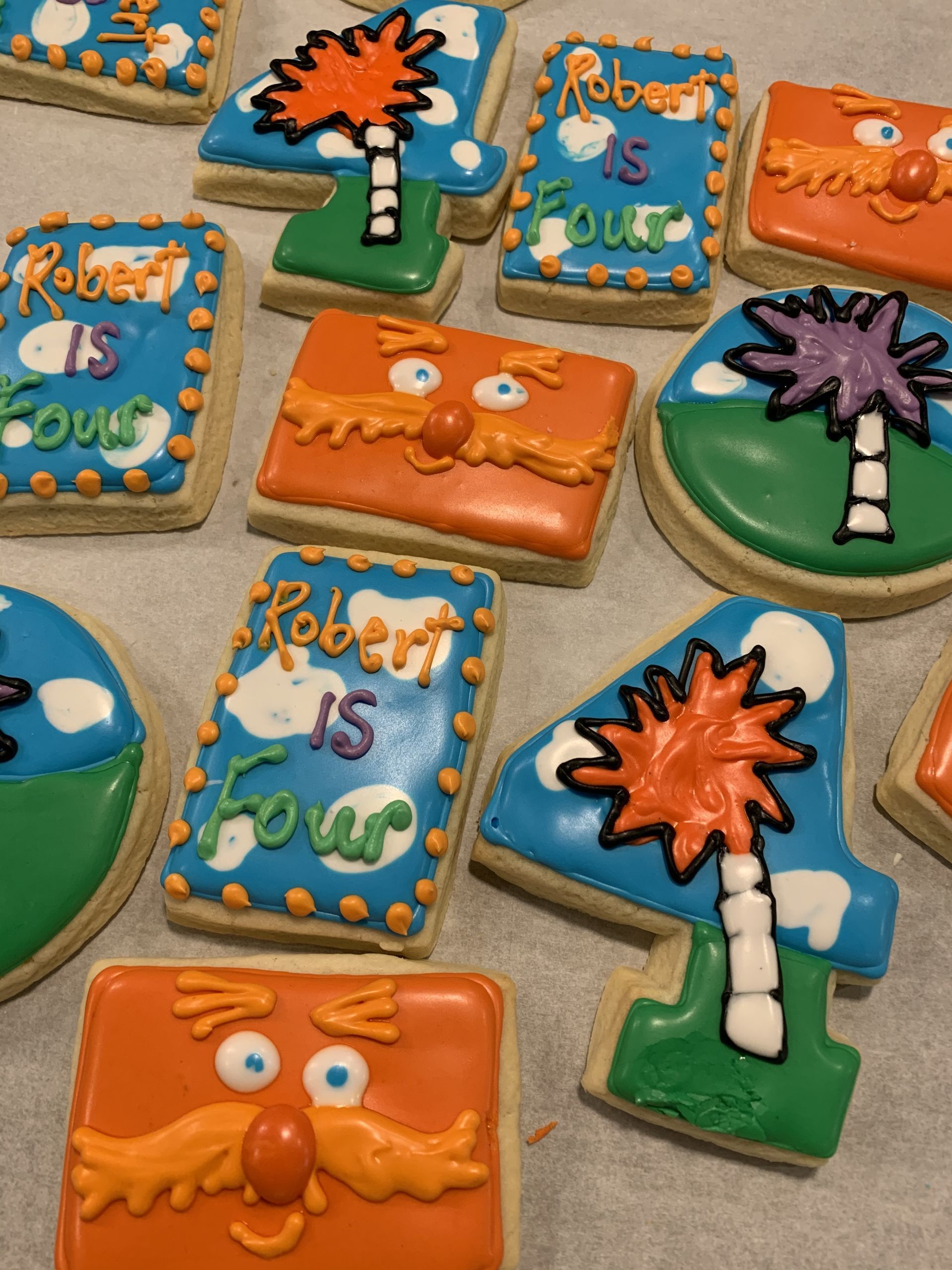 a bunch of cookies with one that says robert is four