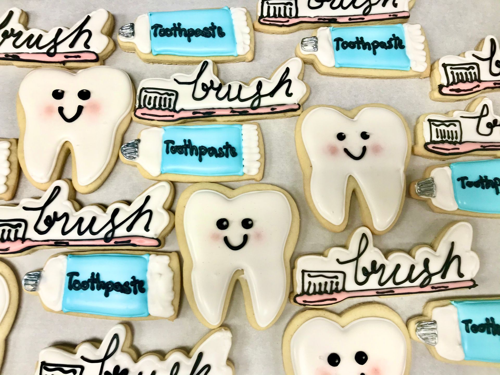 a bunch of cookies with toothpaste and toothbrushes on them