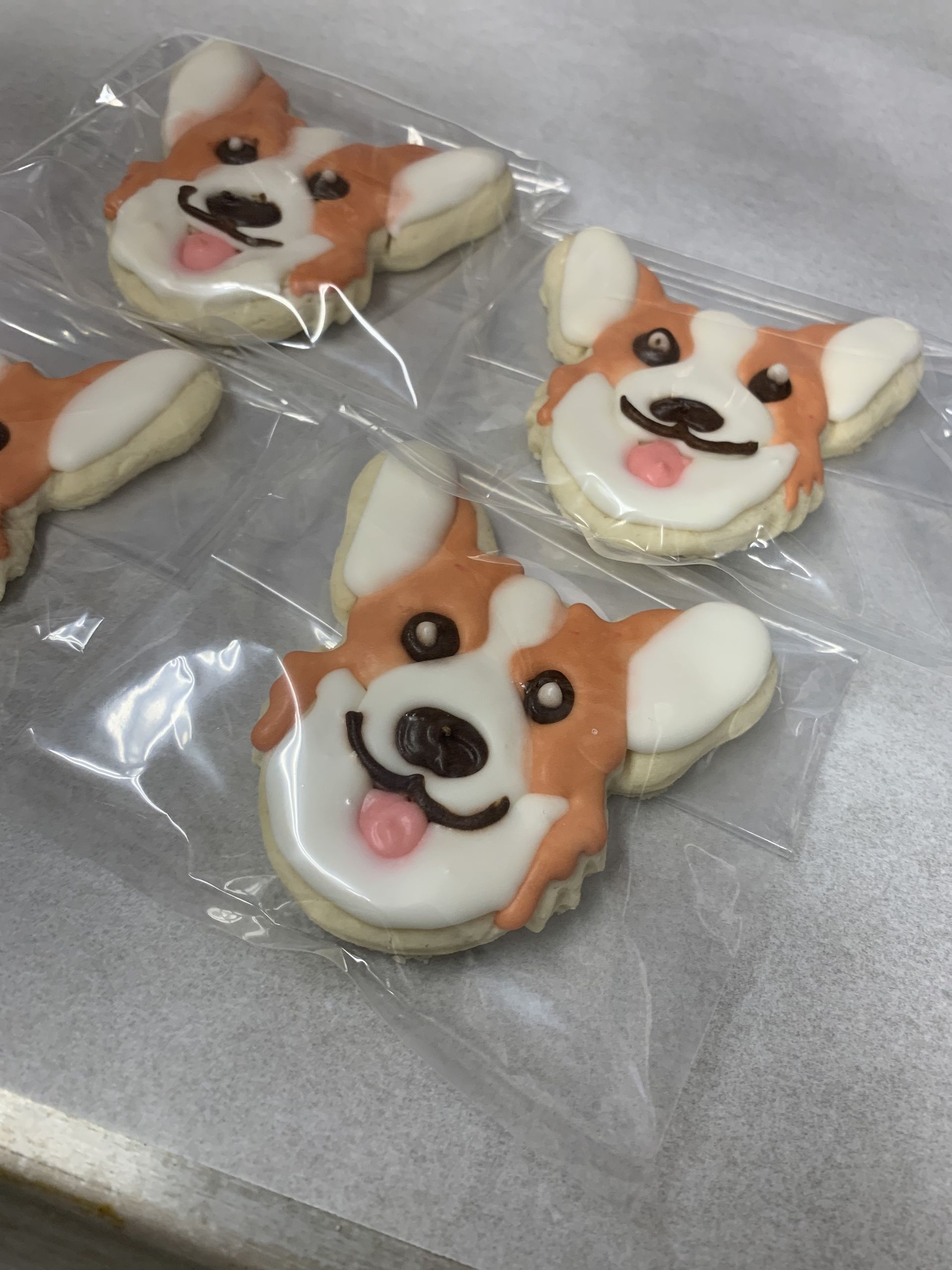 four cookies in the shape of a dog 's face