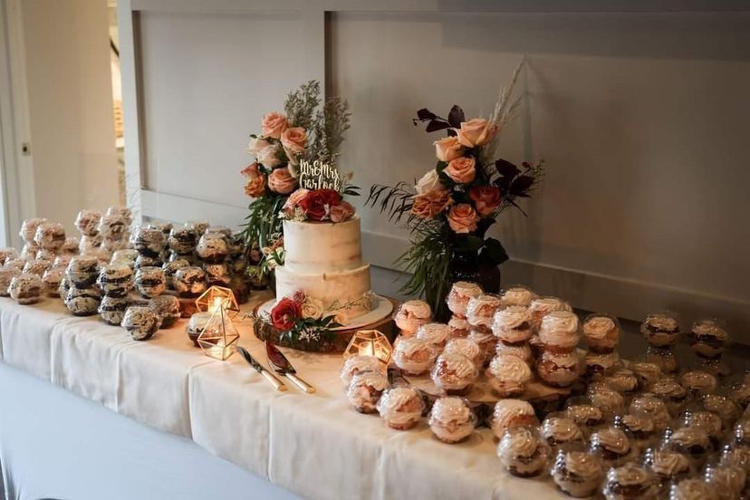 a table with a cake and cupcakes on it .