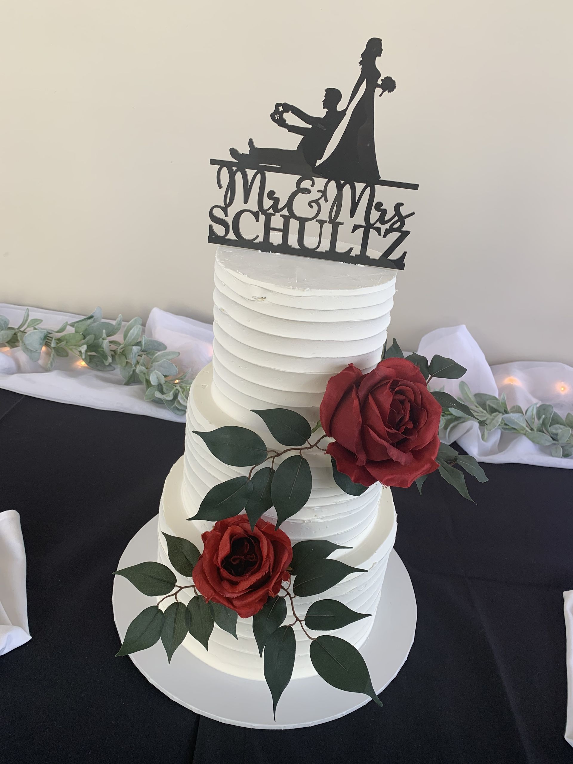 a wedding cake with a topper that says mr. and mrs. schulz